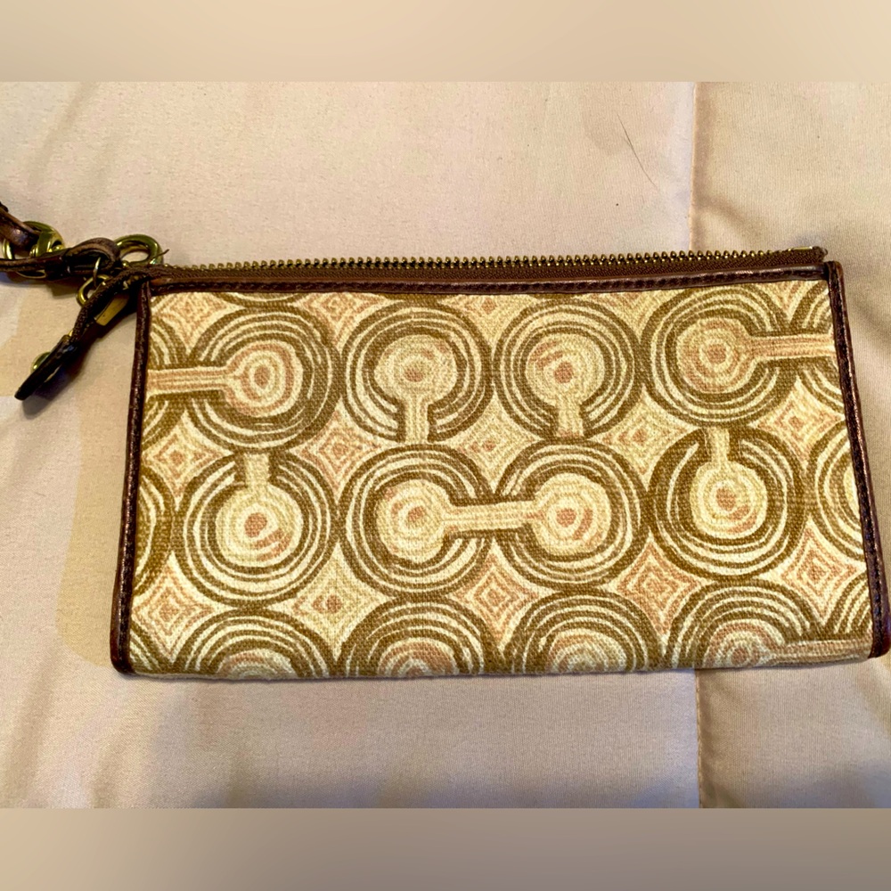Coach wristlet.  Cloth with cream and brown colors